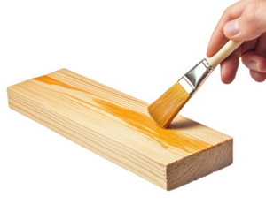 hand holding brush applies varnish to wooden plank, showcasing craftsmanship and attention to detail. This captures essence of woodworking and DIY projects