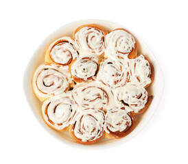 Delicious frosted cinnamon rolls in baking dish isolated on white, top view