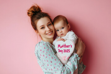 Happy moment for mother and baby celebrating Mother's Day in a serene pink setup in 2025