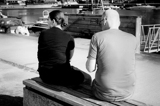 Couple Resting At The Pier