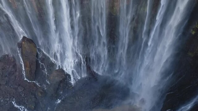 Aerial view of majestic Tumpak Sewu waterfalls in slow motion, Java, Indonesia	