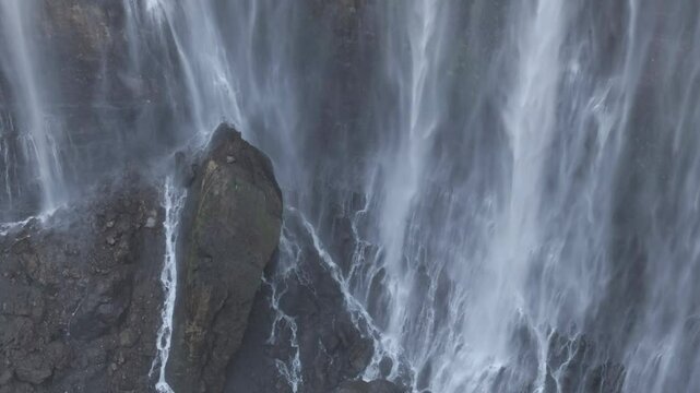 Aerial view of majestic Tumpak Sewu waterfalls in slow motion, Java, Indonesia	