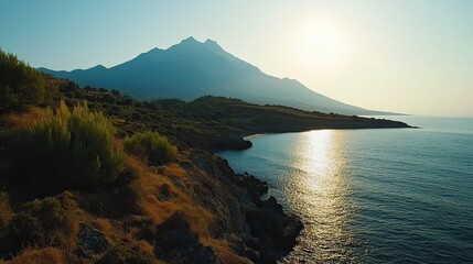 Coastal sunrise landscape, mountain backdrop, calm sea, travel photography