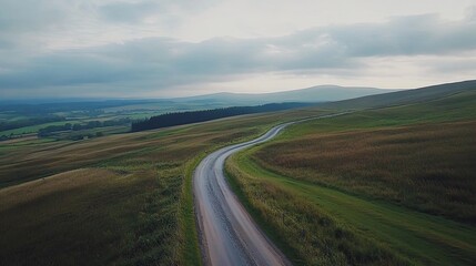 Winding road through Scottish highlands, overcast sky, travel and tourism photography