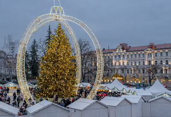 Locals and tourists celebrating the Christmas Holidays of 2024 at the Cathedral Square in Vilnius Old Town, Vilnius, Lithuania