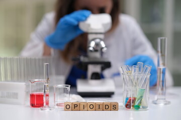 An experienced scientist meticulously examines various samples related to important opioid research...
