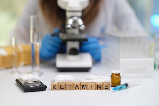 An investigative scene showcasing ketamine along with various laboratory equipment now under expert scrutiny