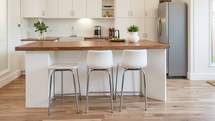 Chic kitchen island with a warm wooden countertop, flanked by sleek bar stools. A modern silver fridge completes this inviting culinary space