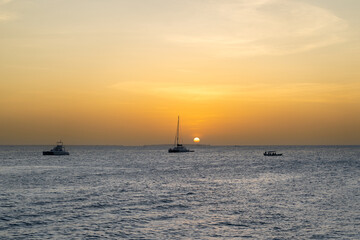 Boats and Sun Dipping Below the Horizon in Zanzibar