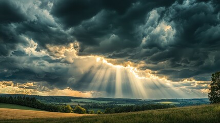 Dramatic storm clouds rolling in over a landscape, with rays of sunlight breaking through