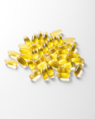 yellow large capsules with fish oil on a white background