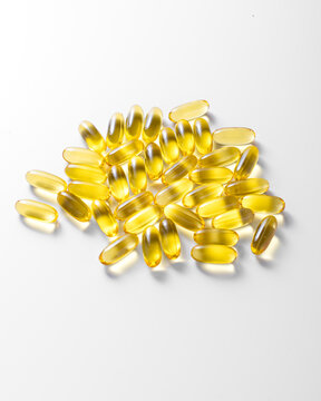 yellow large capsules with fish oil on a white background