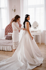 Naklejka premium brunette bride in a tight wedding dress in a studio