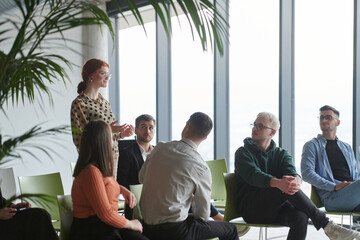 A diverse group of business professionals sits attentively in a modern office, actively participating in a training session led by an instructor, focusing on the latest technological advancements in