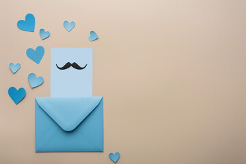 Fathers Day flat lay blue envelope, mustache white card, blue paper hearts, on beige background