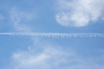 blue sky with white clouds. The sky is clear and bright, and the clouds are scattered throughout the sky. Scene is peaceful and serene, as if the viewer is looking up at a beautiful day