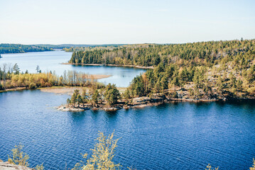 Landscape blue deep lake light sun, clouds sky mountains Ladoga skerries Karelia