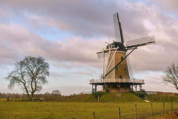 Historic Windmill De Windhond in Soest sitting on the mill hill on a Cloudy Day