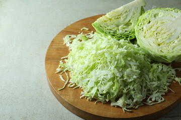 Fresh shredded cabbage on light table, closeup