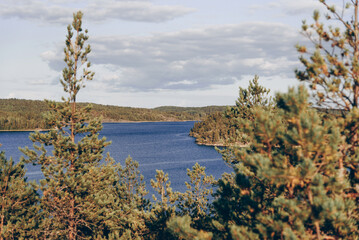 Landscape blue deep lake light sun, clouds sky mountains Ladoga skerries Karelia