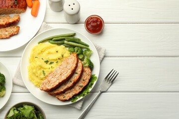 Delicious baked turkey meatloaf with mashed potato served on white wooden table, flat lay. Space for text