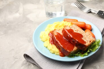 Delicious baked turkey meatloaf with mashed potato served on grey table, closeup. Space for text