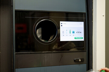 Machine for accepting plastic and aluminum beverage bottles. Ecological recycling of beverage waste.