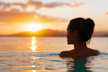 Fototapeta premium Tranquil Sunset View with Woman Silhouette in Calm Water Under Beautiful Orange Sky at Dusk