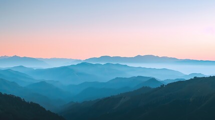 Obraz premium A panoramic view of a mountain range with a pink and blue sky.