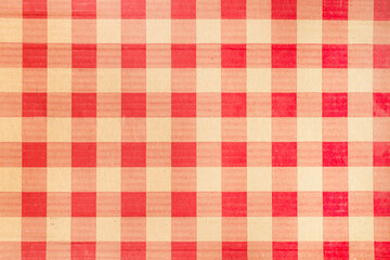 Red and yellow chequered fabric in a close up view