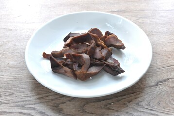fried salty slice ox tungue or Gyutan and pepper arranging on white plate 