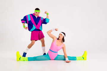 Naklejka premium Dynamic duo in colorful retro sportswear posing with playful energy.