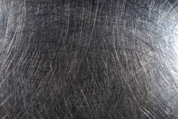 Macro Close-Up of Scratched Stainless Steel Surface with Reflective Circular Patterns