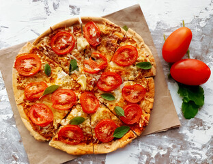 Margherita pizza on rustic white background