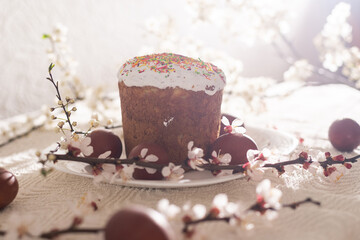 Easter background with colored eggs, colored easter eggs and blooming branches. Easter composition. Easter cake