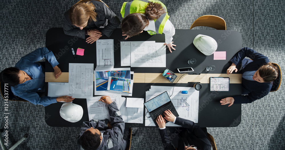 Aufkleber Top Down View of Diverse Team of Real Estate Construction Engineers Working With Blueprints and Documents in an Office. Workspace Of Housing Development Company with Colleagues Using Laptop and Tablet