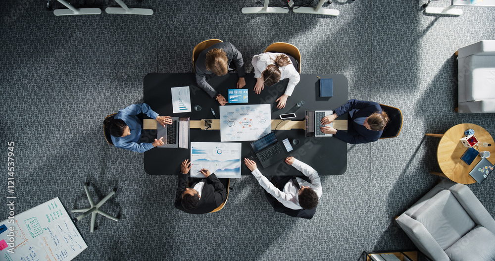 Fototapete top down view: diverse professionals working on business statistics reports and digital plans in an 