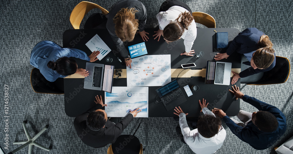 Fototapete diverse professionals working on business statistics reports and marketing plans in an office. top d