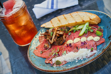 beef carpaccio served with grilled bread