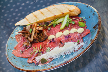 beef carpaccio served with grilled bread