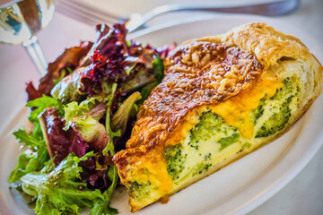 broccoli cheese quiche served with a mixed green salad