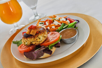 crispy fried crab cake sandwich with a beer