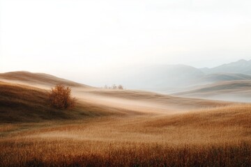 Fototapeta premium Serene landscape with rolling hills and misty atmosphere at dawn.