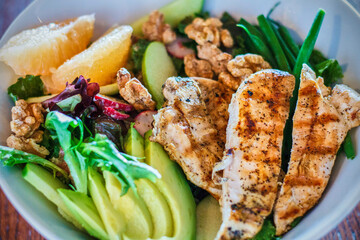 grilled chicken salad with avocado, green bean, and fresh citrus