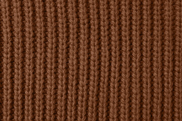 Knitted fabric in mocha mousse shade, closeup. Trendy color of 2025 year