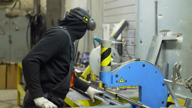 An engineer joins metal on a machine with rivets. Work with metal structures at the industrial plant. High quality 4k footage