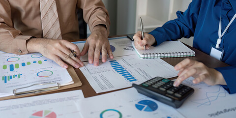 Accountants analyzing financial data and taking notes during a strategy meeting