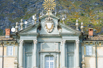 Close up of the ancient entrance gate of the Oropa Shrine, located close to the city of Biella, Italy. Mountains on the background.