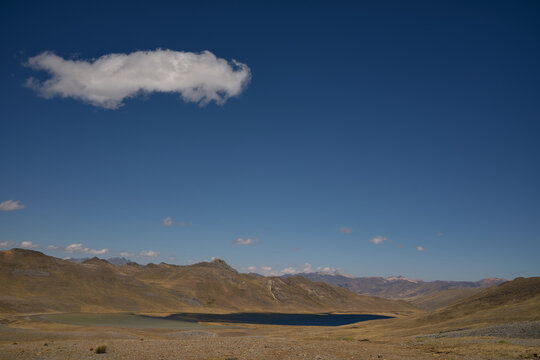 mountain landscape with blue sky and one big cloud