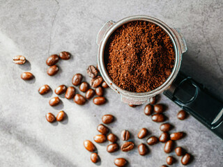 Ground coffee in portafilter filled ready for brewing espresso, Top view